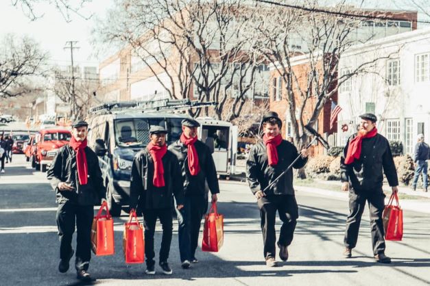 Men holding red bags 
