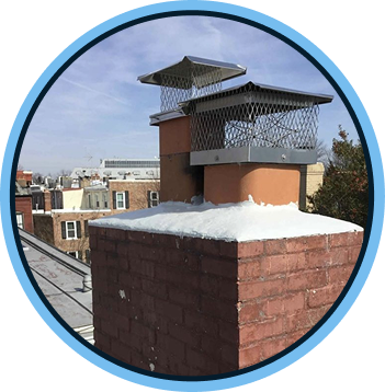 a chimney with snow on top with a city in the background