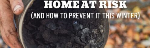 Hand holding a chimney pipe filled with dark creosote buildup during inspection.