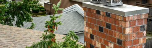 Brick chimney with fallen tree branches and pinecones against the chimney after a storm, image branded by Rooftop Chimney Sweeps, highlighting chimney storm damage and potential repair needs.